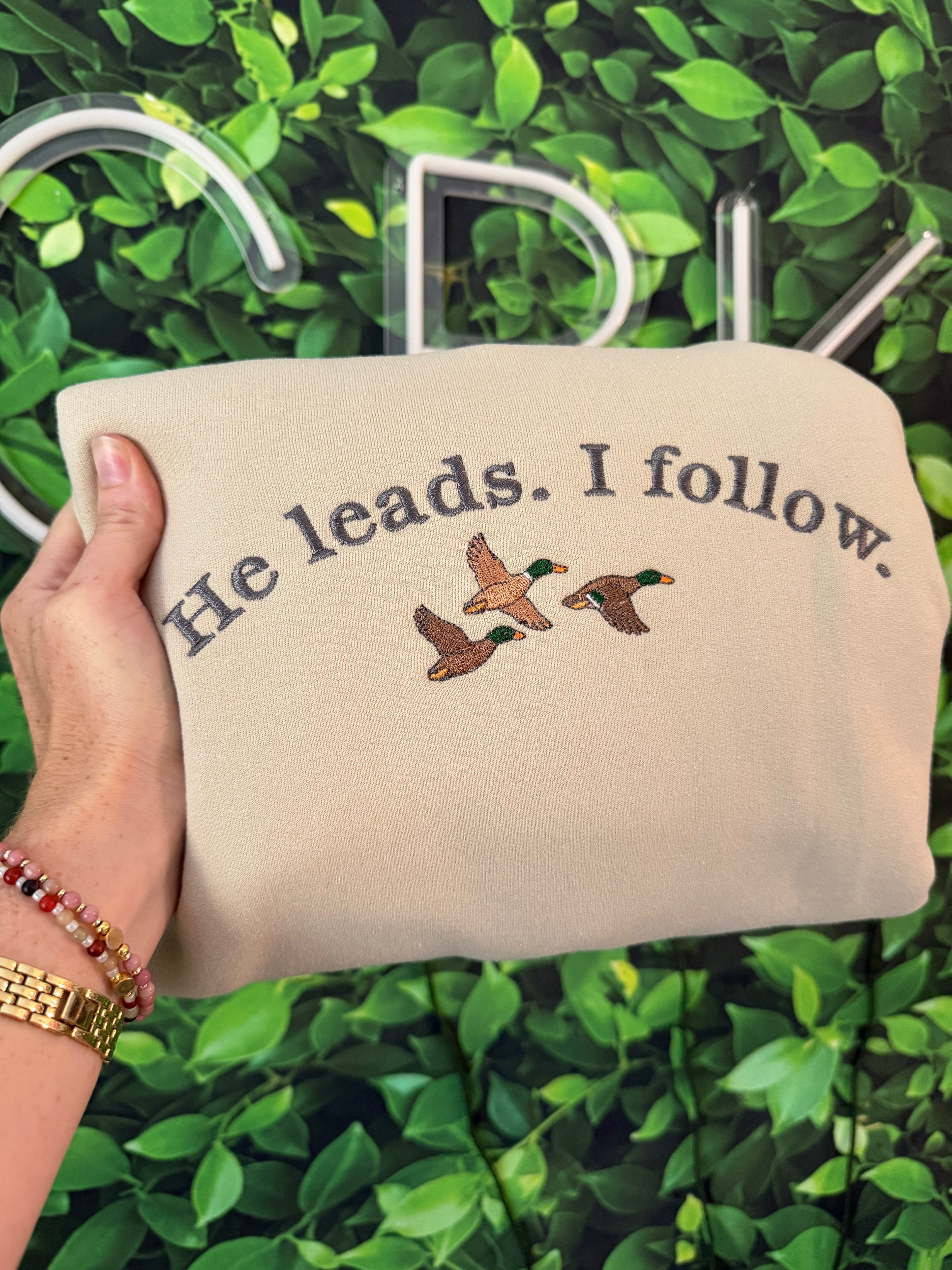 He leads. crewneck